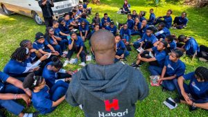 Habari Wi-Fi team member presenting digital solutions to students gaining practical digital skills in Tanzania.