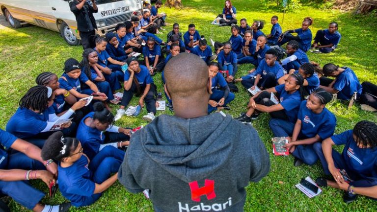 Habari Wi-Fi team member presenting digital solutions to students gaining practical digital skills in Tanzania.